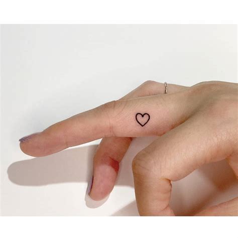 Minimalist Heart Outline Tattoo Done On The Finger