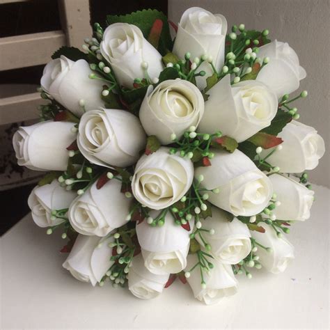 a bridal bouquet featuring artificial silk white roses and gyp abigailrose