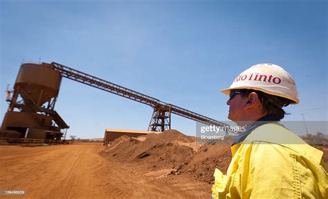 A Mine Worker Looks At A Train Loader At Rio Tinto Groups West News