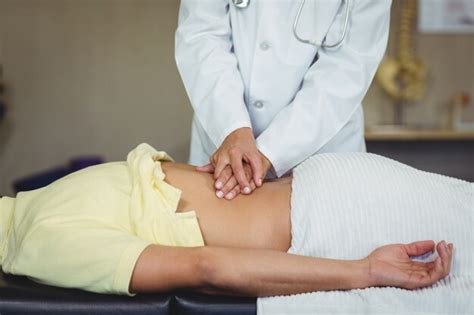 Premium Photo Female Physiotherapist Giving Back Massage To Male Patient