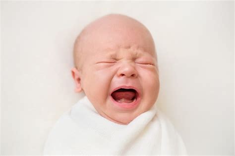 Premium Photo Newborn Baby Boy On A White Background Baby Is Crying