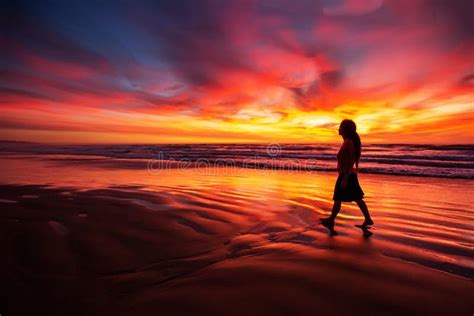 Woman Walking Alone On The Beach In The Sunset Stock Image Image Of
