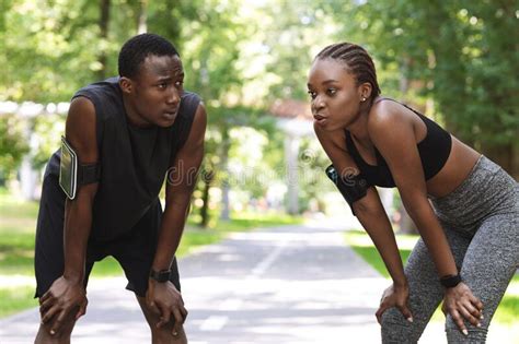 Tired African Couple Taking Breath After Hard Workout Outdoors Resting Together Stock Photo