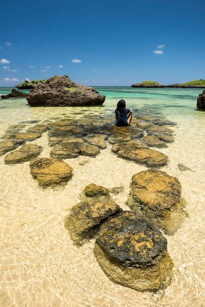 Premium Photo Okinawa Girl Sitting On The Rocks At Hoshizuna Beach