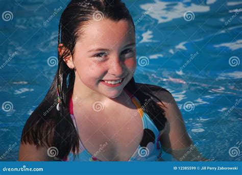 Girl In A Hat Swimming In The River With A Transparent Inflatable Circle In The Shape Of A Heart