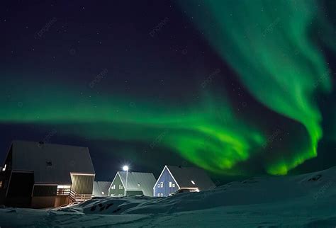 Inuit Houses Under A Spectacular Green Aurora In An Arctic Village