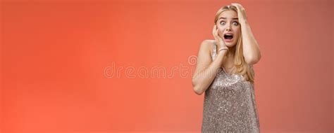 shocked terrified blond woman horrified see crime screaming pop eyes shouting hold hands head