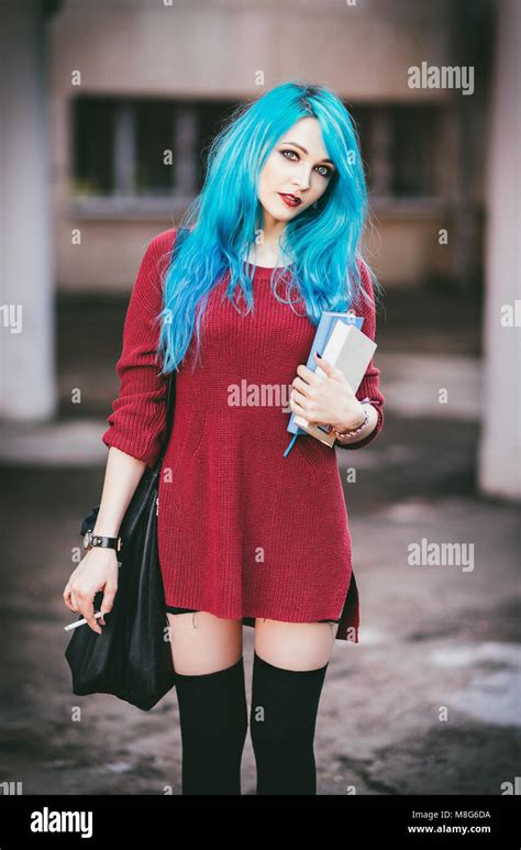 Portrait Of Cute Smiling Blue Haired Grunge Rock Girl With Books And