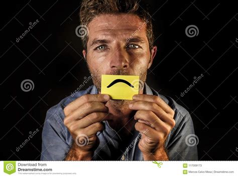 Attractive And Depressed Man Holding Paper With Smiley Sad Mouth Draw