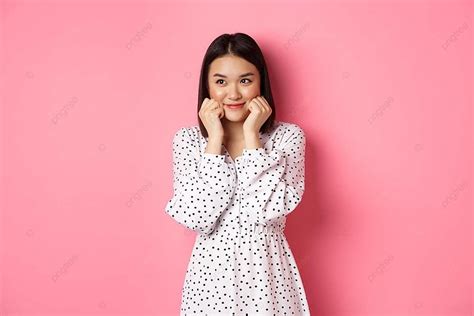 shy asian girl blushing touching cheeks with copy space photo background and picture for free