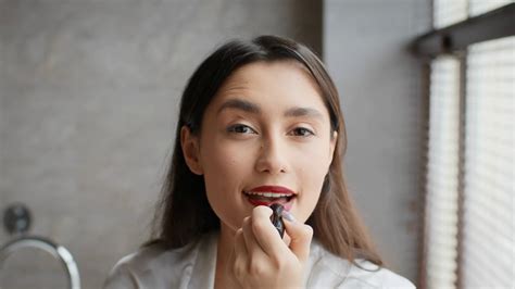 Brunette Lady Applying Bright Lipstick Making Makeup In Bathroom Stock