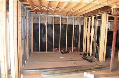 Staring at the concrete walls and not sure how to frame against? The Bennett House: Basement Framing
