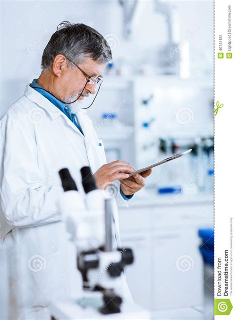 Senior Male Researcher Carrying Out Scientific Research In A Lab Stock