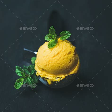 refreshing mango sorbet ice cream scoop  scooper square crop stock photo  sonyakamoz
