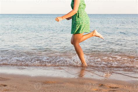 Leg Of Woman Running On Beach With Water Splashing Summer Vacation