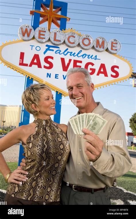 Middle Aged Couple In Front Of Welcome To Las Vegas Sign Portrait