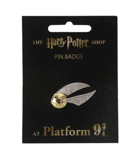 The Harry Potter Pin Badge Is Shown In Front Of A Black Card With Gold Foil
