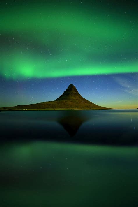 The King Kirkjufell Mountain By Night That Reflecting In The Sea With