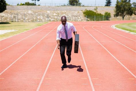 Businessman Running On A Running Track Stock Photo Image Of Carrying
