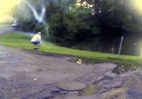 A White Bird Standing On Top Of A Dirt Road