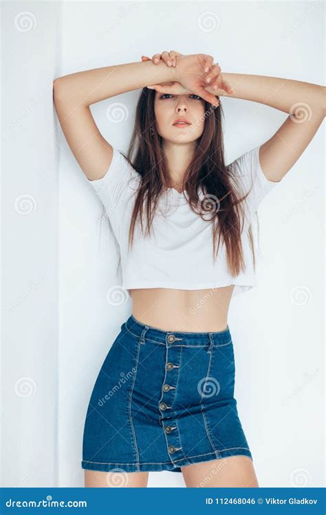 Confident Beautiful Woman Stands With Hands Raised At Forehead Stock