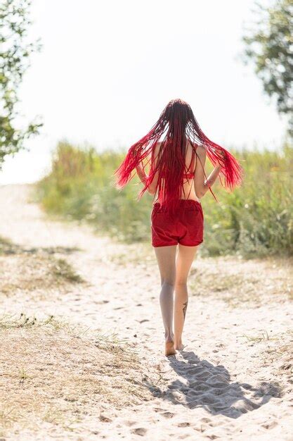 premium photo beautiful girl outdoors enjoying nature seminude girl with scarlet dreadlocks