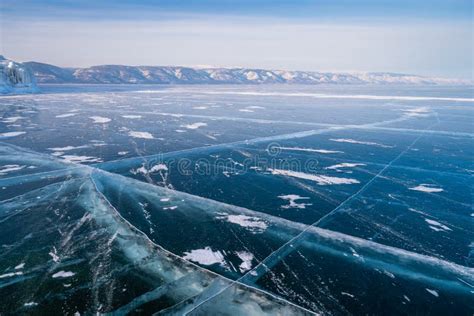 Baikal Frozen Lake In Winter Season With Cracks On Ice Floor Siberia