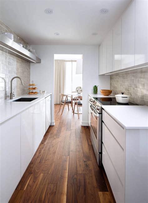 The white cabinets are complemented by gray countertops, while a yellow accent wall helps to elongate the space. 10 Galley Kitchen Ideas 2020 (Beauty in Limited Space)