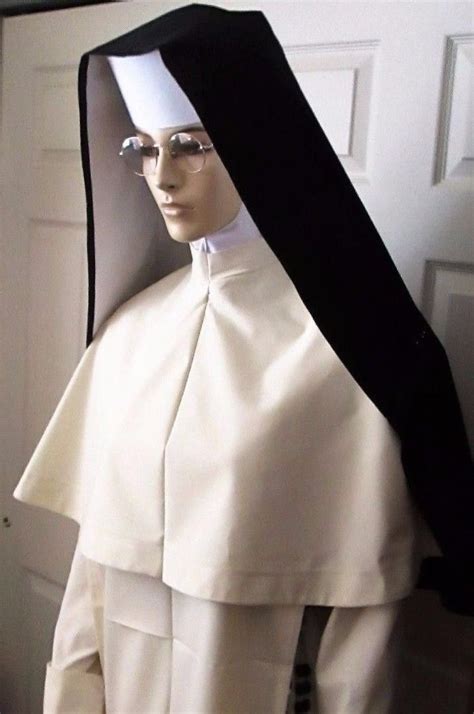 a mannequin dressed in white and black with a nun s hat on