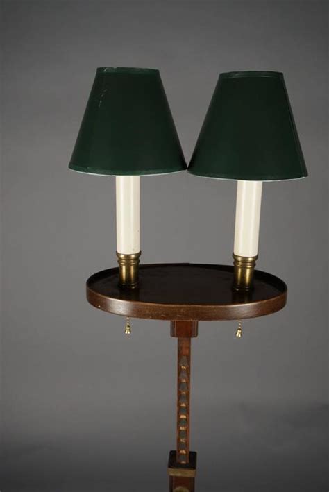 Base is made of wood, which is straight and craved with design and pattern over it. Pair of Colonial Revival Adjustable Floor Lamps at 1stdibs
