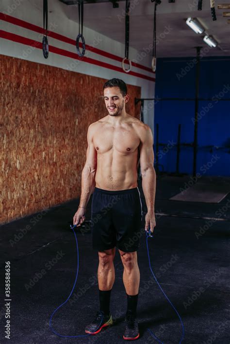 Active Male Athlete With Naked Torso Using Skipping Rope During Training While Working On