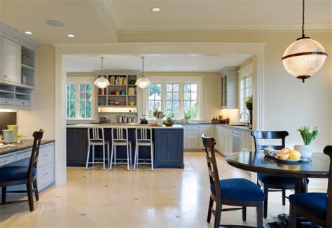 The dining table, preparation table and chairs are nice complement to the blue cabinets. 30 Kitchen Chairs With Modern Flair