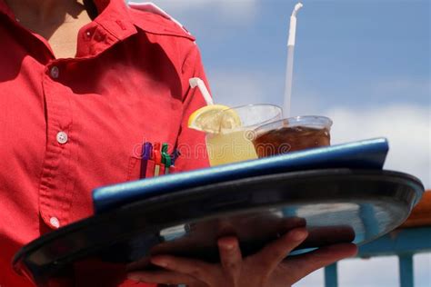 Waitress With Two Drinks Against A Blue Sky On A Cruise Ship By The Pool Sponsored Paid