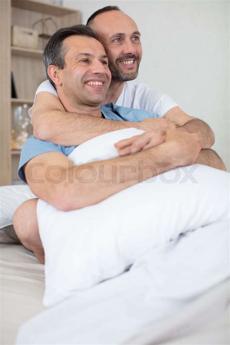 Gay Couple Cuddle In Bed Together Stock Image Colourbox
