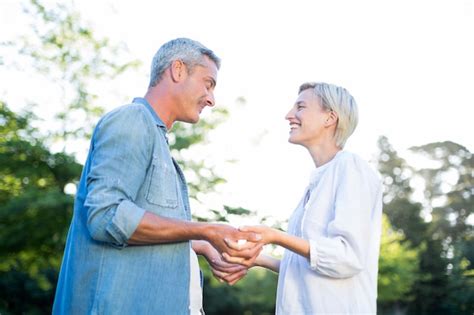 Premium Photo Happy Couple Holding Their Hands At The Park