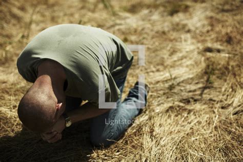 Stock Photo A Desperate Man On His Knees Praying To God By Pearl