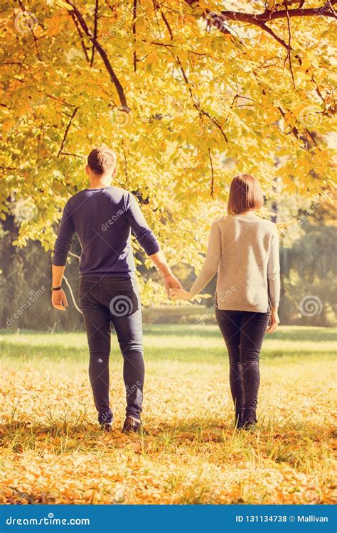 Young Couple Walking In Autumn Park Stock Photo Image Of Boyfriend