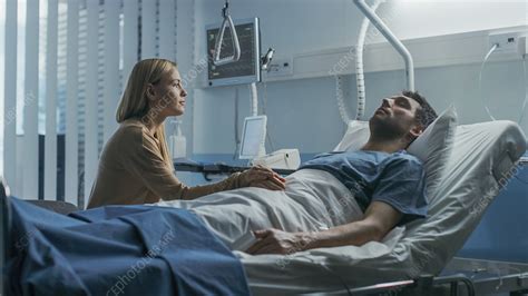 Wife Sitting Beside Her Husband S Hospital Bed Stock Image F033 3200 Science Photo Library