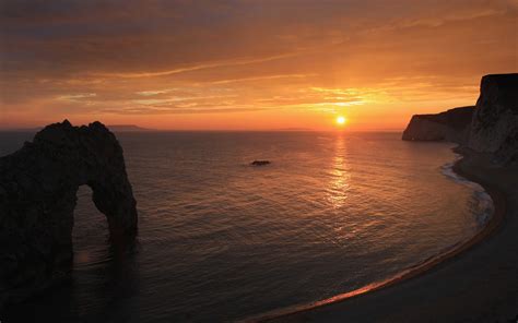 Durdle Door Is A Natural Limestone Arch On The Jurassic Coast Near