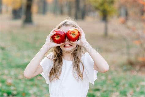 Girl With Apple Holding In Front Of Her Face In Park Beautiful Girl