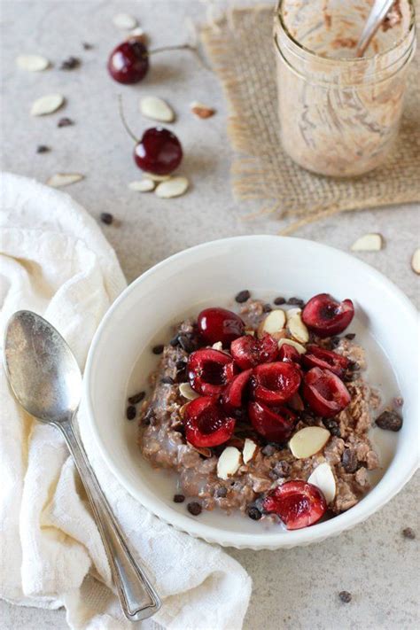 A Bowl Of Oatmeal With Cherries And Almonds On The Side