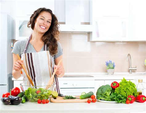 Home cooking health benefits allow you to eat better and still use food as a social bond while social distancing during coronavirus. Young Woman Cooking. Healthy Food