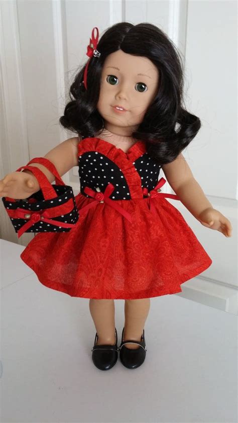 The Doll Is Wearing A Red Dress And Black Shoes