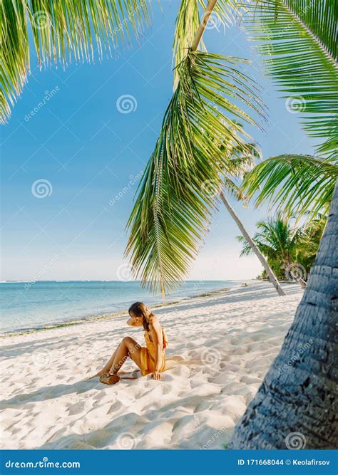 Young Woman In Dress Relaxing At Tropical Palm Beach Tropical Vacation
