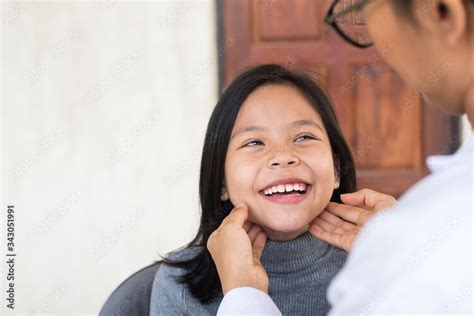 Child With Doctor Pediatrician Probing Touching Lymph Nodes On Neck Of