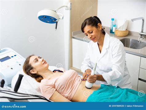 Woman Cosmetologist Making Ultrasound Lifting Procedure Stock Photo