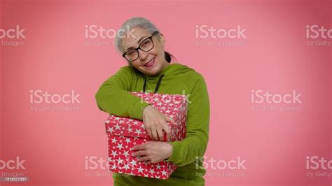 Cheerful Senior Grandmother Woman Opening T Box And Smiling Joyfully