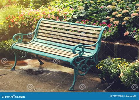 Vintage Bench In Flower Garden With Vintage Light Filter Stock Photo