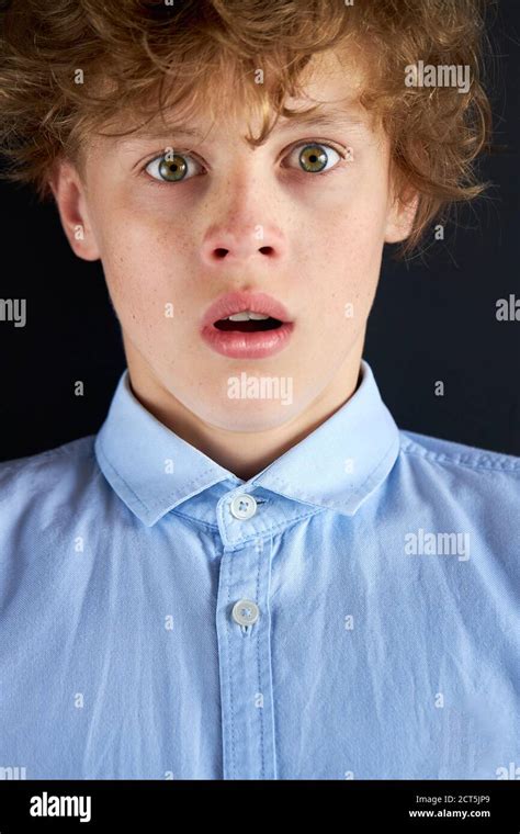 Close Up Portrait Of Surprised Caucasian Boy Looking At Camera With Big