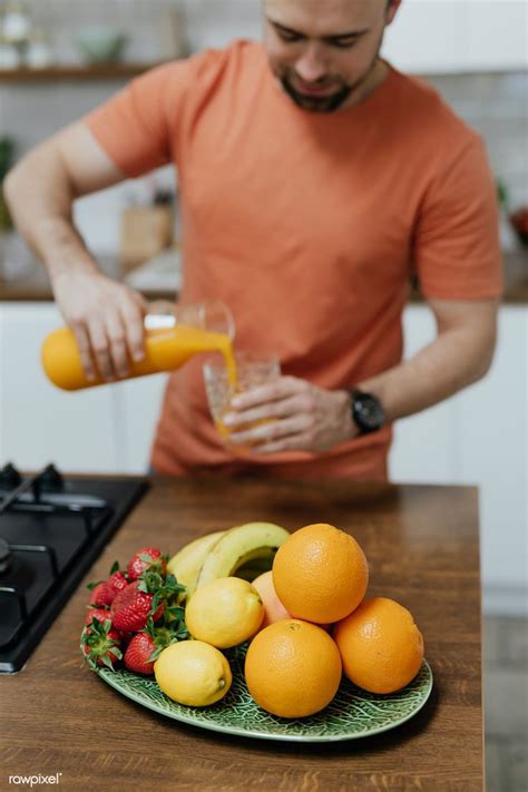 Man Pouring Orange Juice Into A Glass Premium Image By Rawpixel
